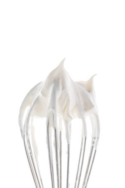 Large whisk topped with whipped cream peaks.