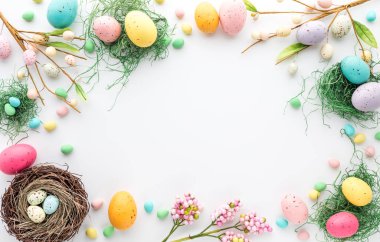 Top down view of an Easter border frame of robins eggs and chocolate eggs with copy space in the middle