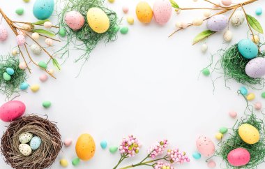 Top down view of an Easter border frame of robins eggs and chocolate eggs with copy space in the middle clipart