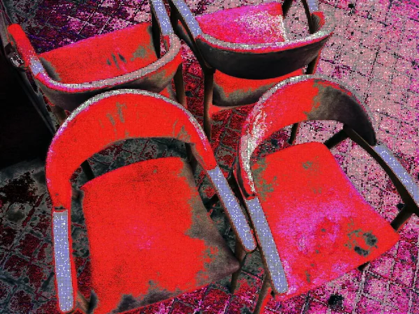 Four red chairs with their backs on the sidewalk of the street