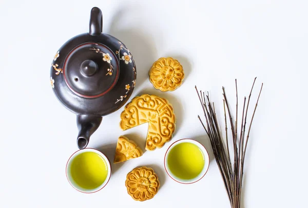 Mooncake and tea, food and drink for Chinese mid autumn festival. Isolated on white background