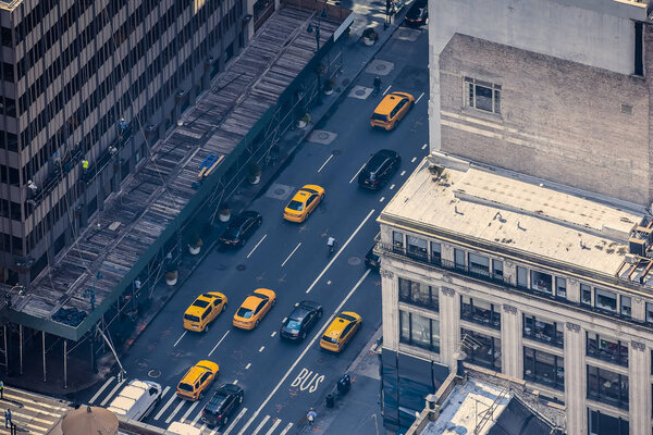 Airstrip of New York City, with buildings and streets filled with the famous yellow taxis during the day. Concept of travel and transport. NYC, USA.