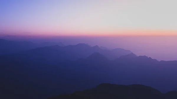 Amazing view of sunrise upon mountains with fog
