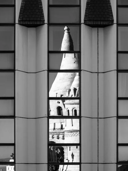 Reflection of Fishermans Bastion, aka Halaszbastya, fairy tale towers in modern hotel windows. Architectural contrast in Budapest — Stock Photo, Image