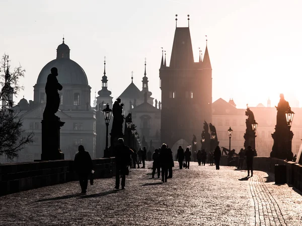 Ομίχλη το πρωί στην γέφυρα του Καρόλου, Πράγα, Δημοκρατία της Τσεχίας. Ανατολή του ηλίου με σιλουέτες περπάτημα ανθρώπων, αγάλματα και πύργοι της παλιάς πόλης. Ρομαντικά ταξίδια destionation — Φωτογραφία Αρχείου