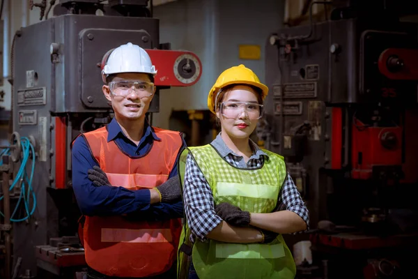 Portrait woman worker and engineer under inspection and checking production process on factory station by wearing safety mask to protect for pollution and virus in factory.