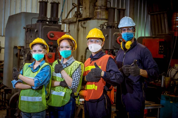 Portrait worker under inspection and checking production process on factory station and safety mask face to protect for pollution and virus in factory.