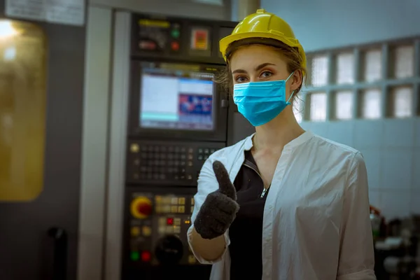 Portrait worker under inspection and checking production process on factory station and safety mask face to protect for pollution and virus in factory.