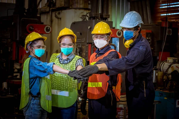 Portrait worker under inspection and checking production process on factory station and safety mask face to protect for pollution and virus in factory.