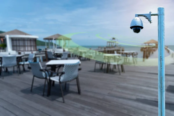 A Speed dome CCTV  infrared camera  technology 4.0 for look security area of people at restaurant and hotel signage with checking in security area.