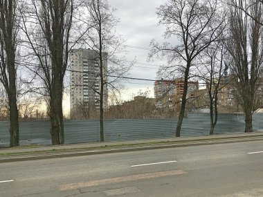 Uyku alanının panoraması. Çitler ve bariyerler. Modern yüksek binalar. 