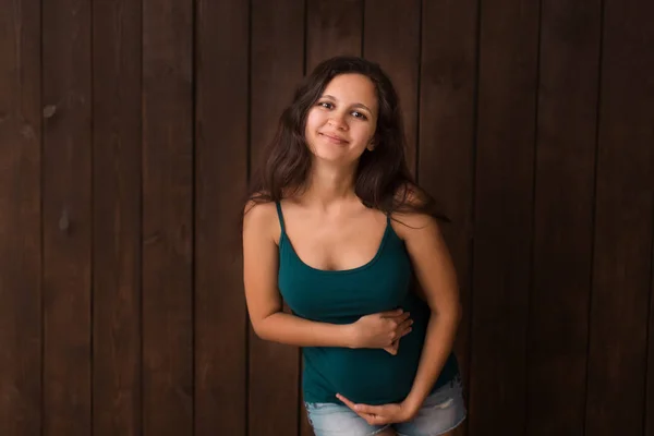 Pregnant Woman Jeans Shorts Green Top Holds Hands Belly Dark Royalty Free Stock Photos