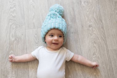 Yeni doğmuş bebek. Beyaz elbiseli ve mavi şapkalı küçük bir çocuk. Bir bebeğin güzel portresi. Koca gözlü bebek..