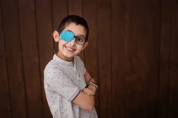 Portrait of boy in glasses with patch. Eye patch for glasses t treat lazy eye, amblyopia, strabismus.