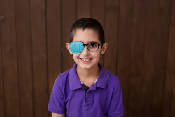 Portrait of boy in glasses with patch. Eye patch for glasses t treat lazy eye, amblyopia, strabismus.