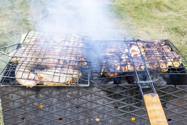 barbecue grill, smoke goes through the meat on the grill