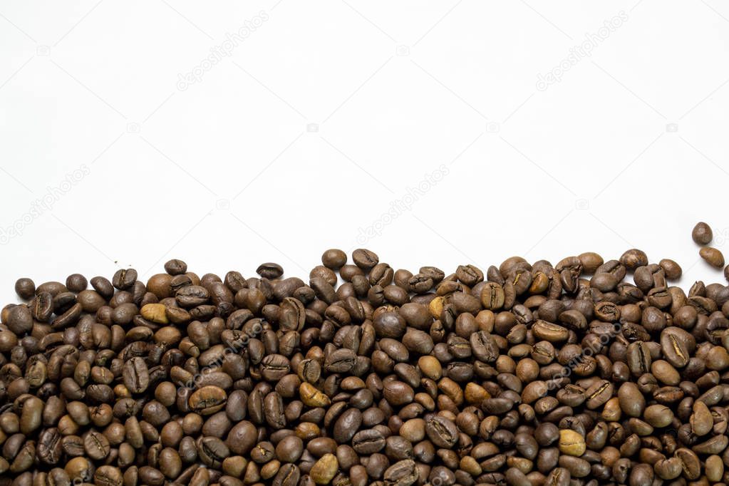 coffee beans sprinkled on a table isolated on a white background