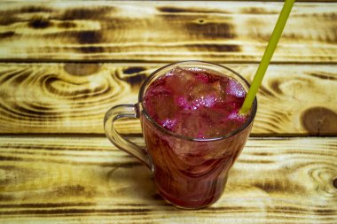 Pomegranate juice with ice, selective focus with shallow depth of field, warm filter