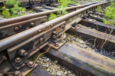 rail fastening to sleepers with rusty bolts clipart
