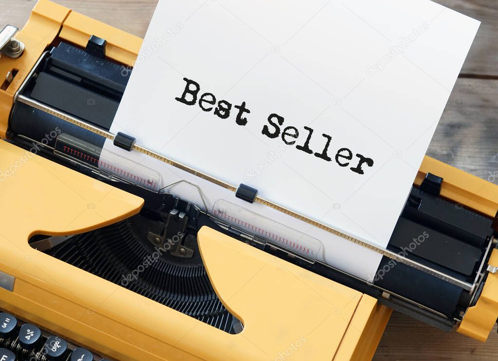 Best seller on white sheet paper in yellow vintage typewriter - book publication