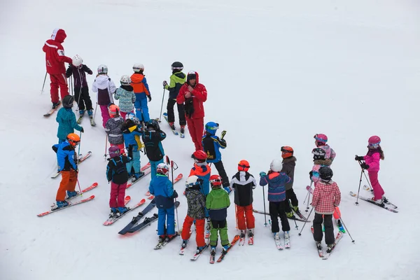 CHAMONIX, FRANCE. March 13, 2018: Ski school with numerous children in chamonix in France. Beginners group with ski instructor. On snow-covered snowfield.