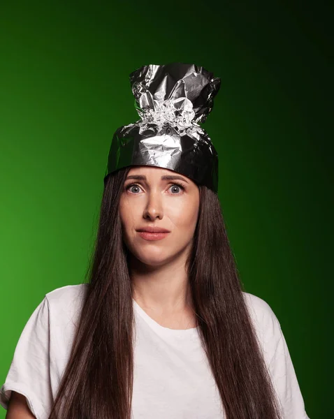 Good looking woman wearing tin foil hat Royalty Free Stock Images