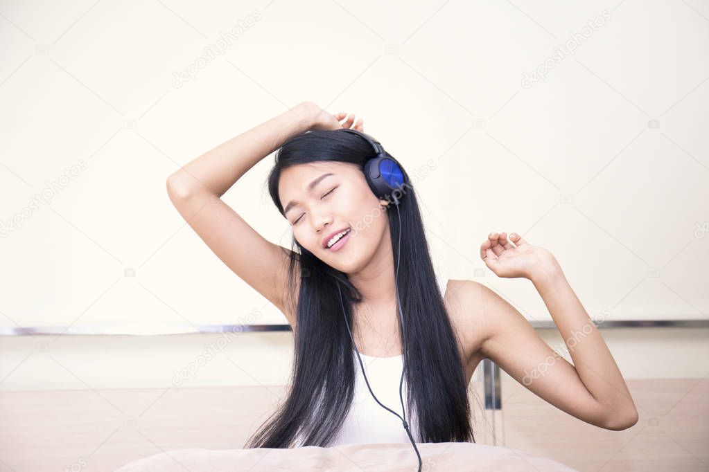 Happy cheerful girl listening music