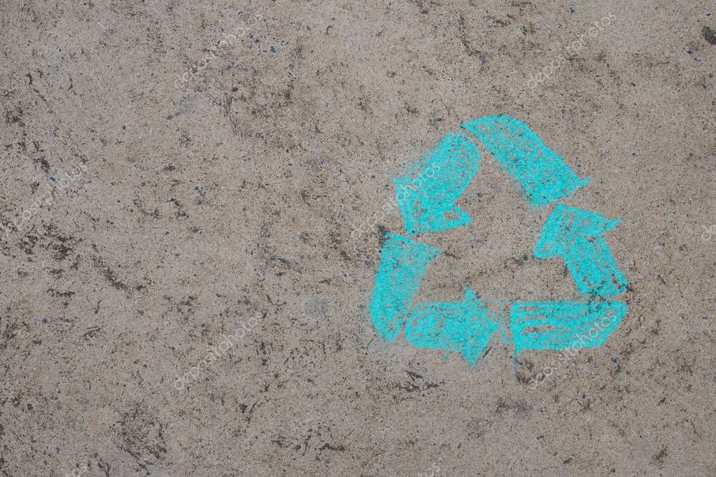 Chalk drawing logo of recycling on street floor