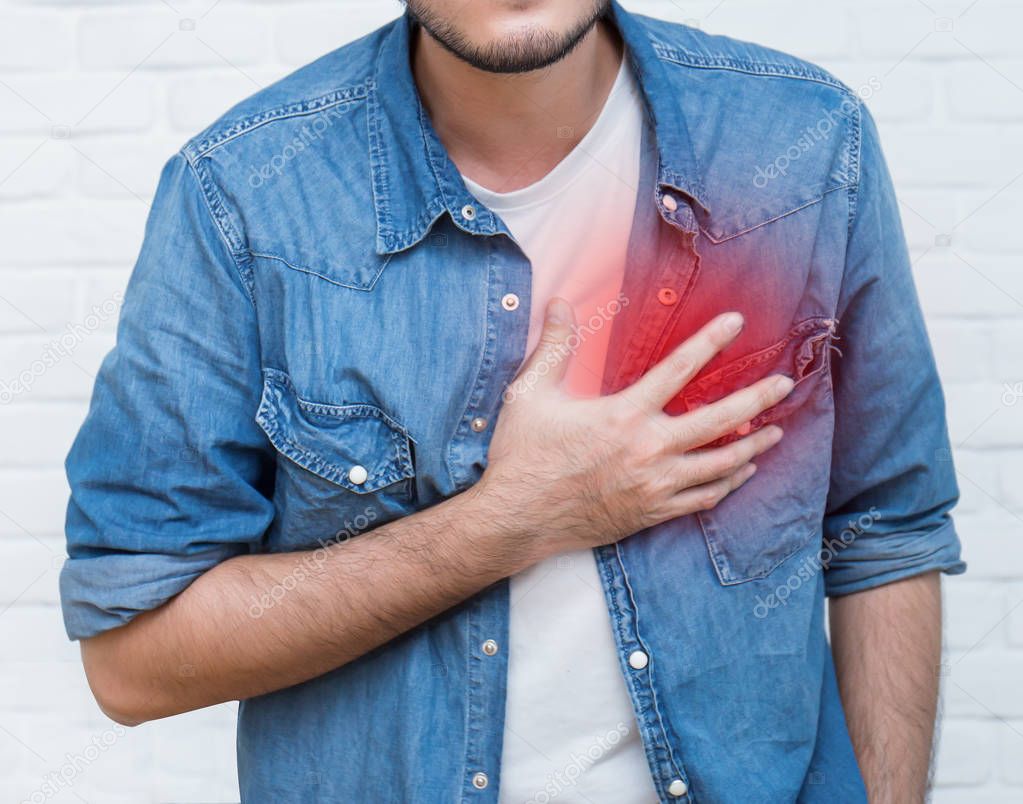 Young man having heart attack, healthcare and medical concept