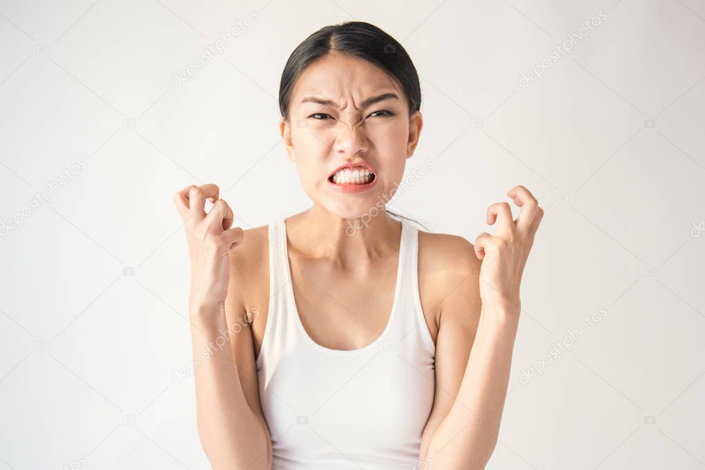 portrait of expressionless angry asian woman screaming out isolated on white background