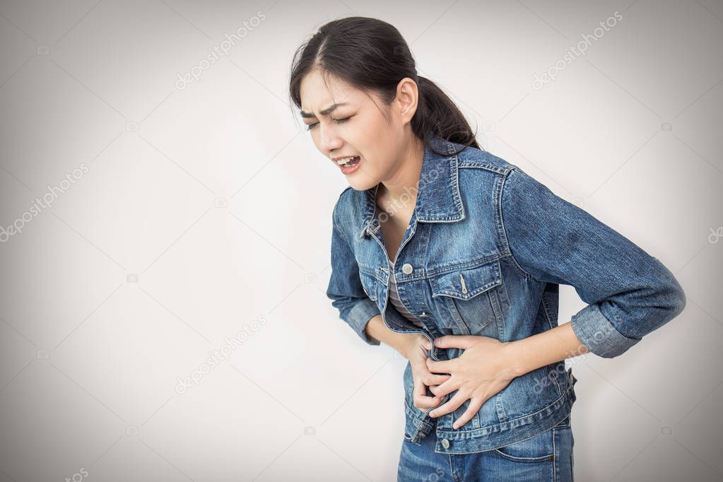 Young asian woman having pain in stomach isolated on white background
