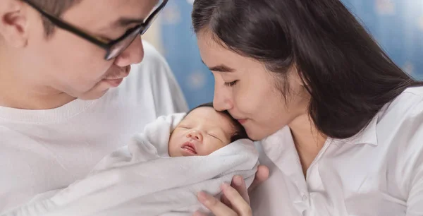 Mother Fathers Hands Holding Newborn Baby Feet Closeup Hands Asian — Stock Photo, Image