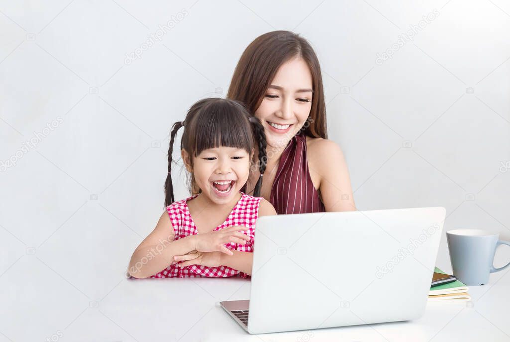Portrait of asian family woman and little girl in home office business, family freelancer mother daughter in sme small business, SME internet work from home business, single mom quarantine e-learning concept