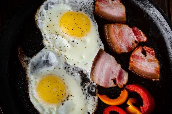 Fried eggs in a frying pan in a rural