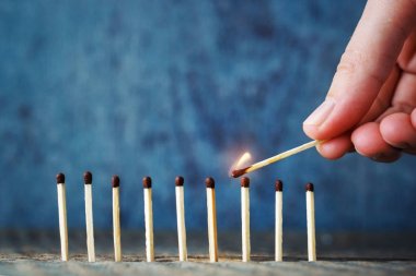 Bir sigara daha yakmaya elinde yanan bir maç çalışır. Konsantrasyon