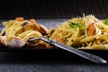 Makarna karides ve midye bir d üzerinde bir tabakta krem sos ile