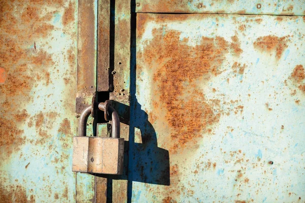 Старый железный замок на металлической ржавой двери — стоковое фото