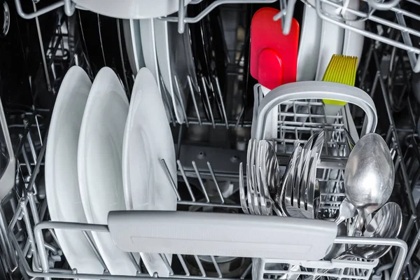 clean dishes in the basket of the dishwasher