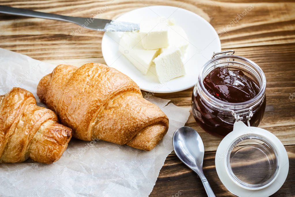 morning coffee with croissants on a wooden table