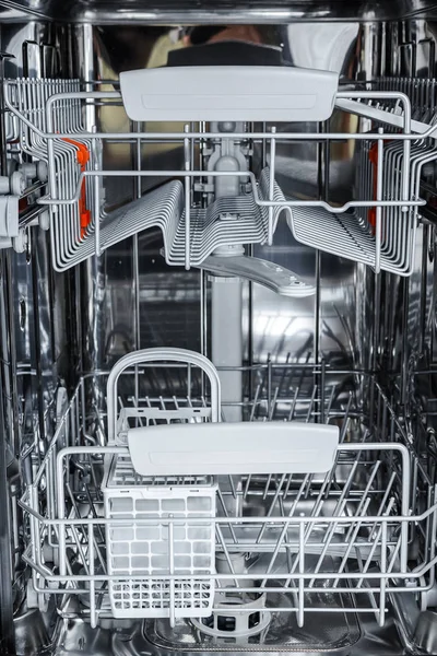 open dishwasher is ready to load dirty dishes.