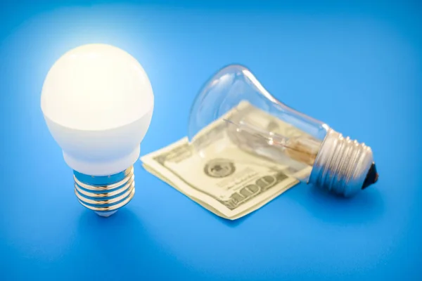 Led light bulb lay next to incandescent bulb