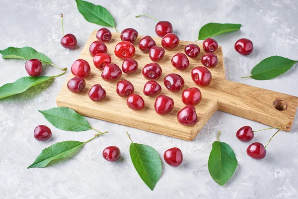 Ripe cherry berries and cherry leaves, closeup