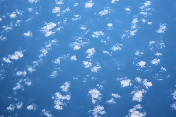 Blue cloudy sky, view from the airplane window. Aerial view of c