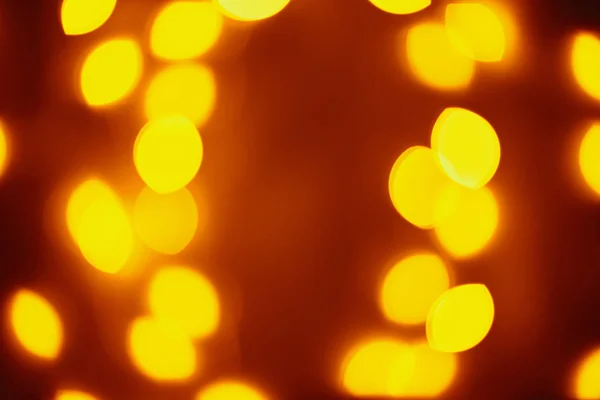 Background of golden lights in a bokeh. Defocused abstract blurred lights — Stock Photo, Image
