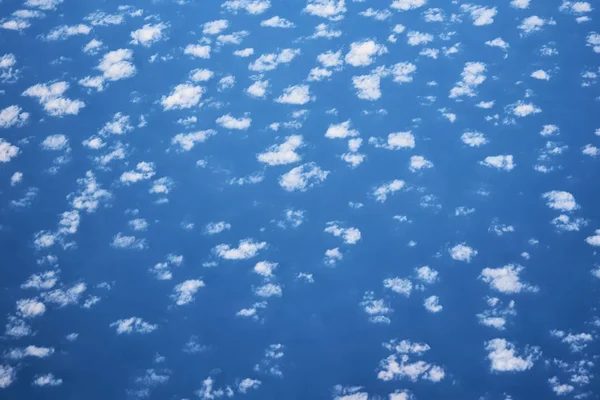 Blue cloudy sky, view from the airplane window. Aerial view of c