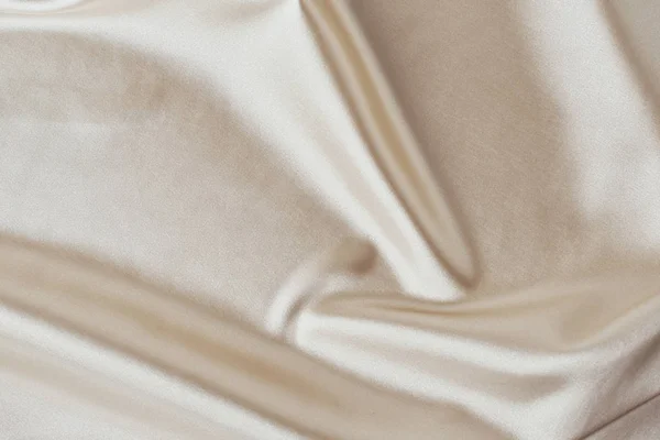 Golden light silk background with a folds.  Abstract texture of rippled satin surface — 스톡 사진