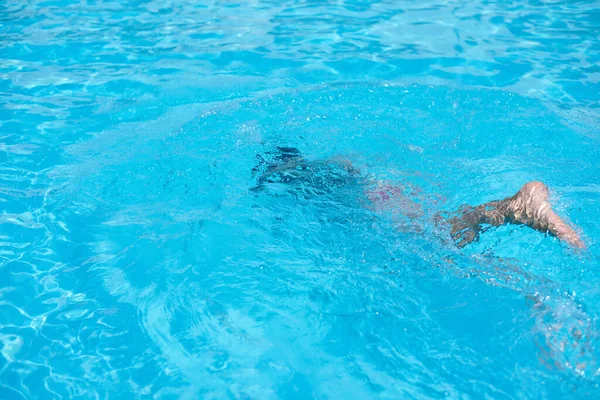Chlapec v potápěčské masce plavat pod vodou v bazénu — Stock fotografie