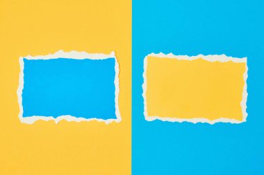 Mavi ve sarı arka planda iki yırtık kağıt. Renk kağıdıyla şablon