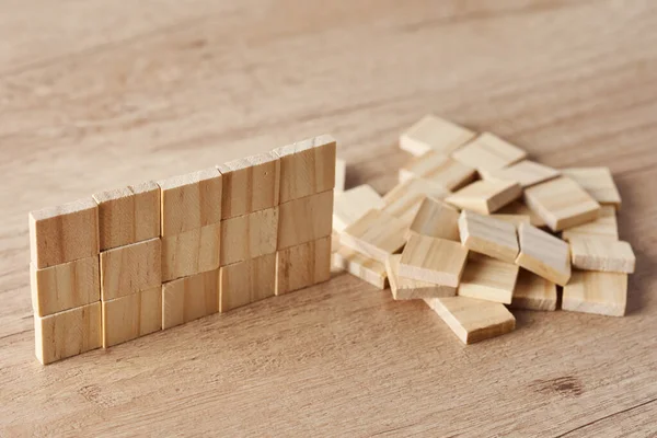 木のテーブルの上に木製のブロックで作られた壁 仕事のコンセプト — ストック写真