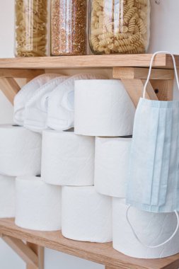 Coronavirus covid-19 konsepti için panik satın alan tüketici. Tuvalet kağıdı rulo, makarna ve karabuğday evde rafta. İnsanlar ev karantinası için gerekli malzemeleri stokluyorlar.
